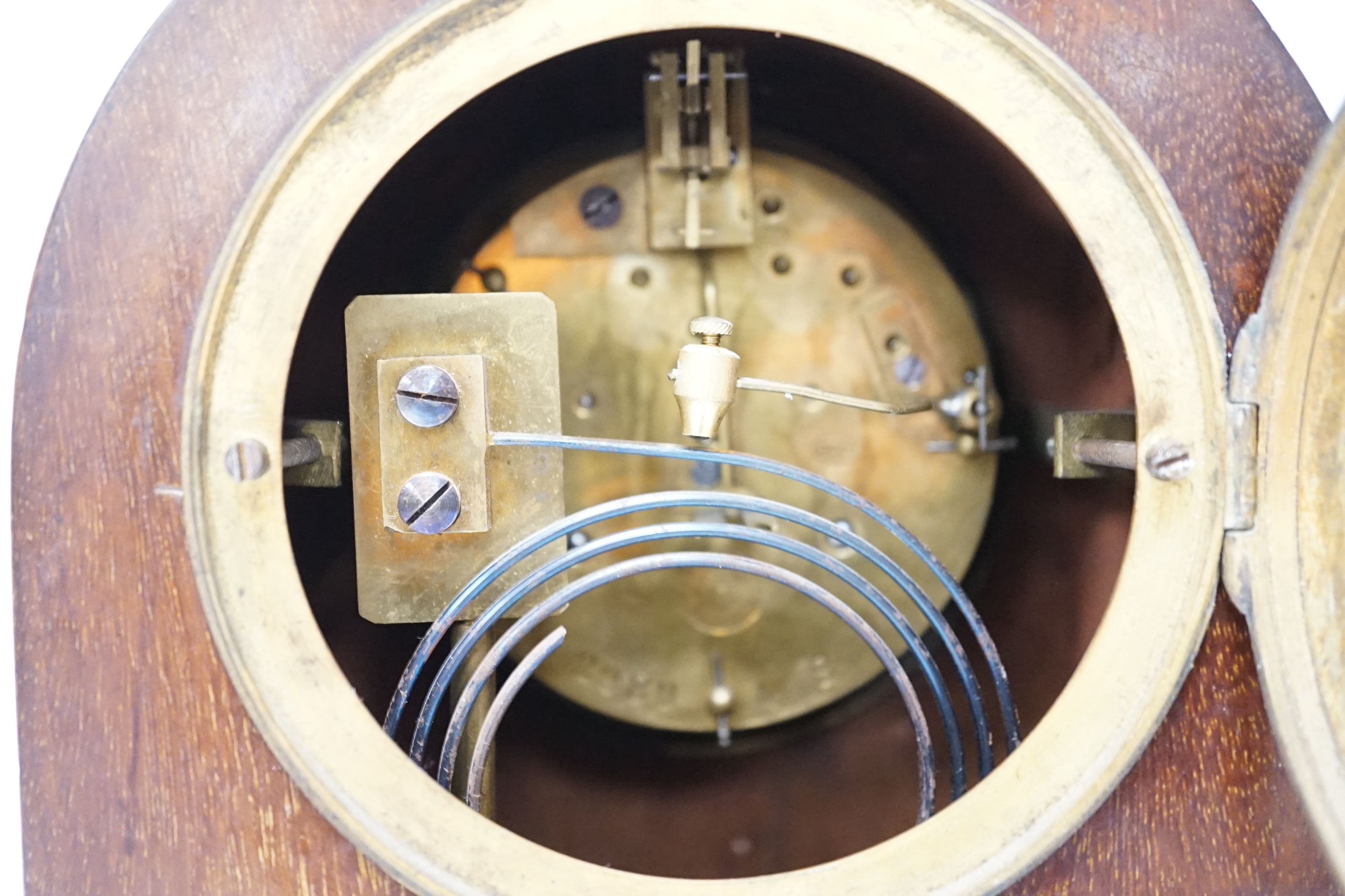 An Edwardian mahogany mantel clock, French movement striking on a coiled gong, 25cm high